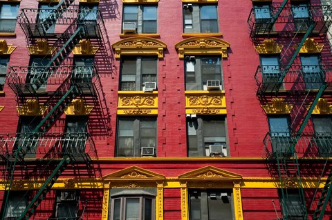 Brightly painted red and yellow building in Chinatown in New York City.